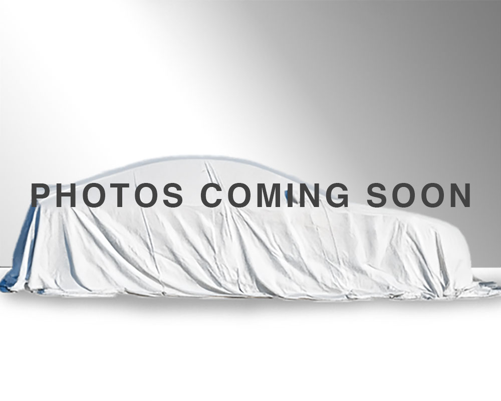 Vehicle with white sheet covering it, text reads coming soon